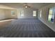 Spacious living room with grey carpet, vaulted ceiling, and lots of natural light at 45 New Bethel Ct, Lillington, NC 27546