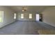 Spacious living room with grey carpet, vaulted ceiling, and lots of natural light at 45 New Bethel Ct, Lillington, NC 27546