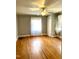 Hardwood floor bedroom with ceiling fan and closet at 504 Summitt Dr, Sanford, NC 27330