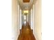 Long hallway with hardwood floors and access to bedrooms at 504 Summitt Dr, Sanford, NC 27330
