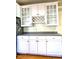White kitchen cabinets, granite countertops and a wine rack at 504 Summitt Dr, Sanford, NC 27330