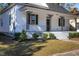 White house with a black door, porch, and landscaped yard at 704 Pender St, Rocky Mount, NC 27801