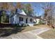 Front view of a charming white house with a black door and porch at 704 Pender St, Rocky Mount, NC 27801