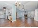 Open living room with wood floors, fireplace, and kitchen views at 9100 Greenbriar Sta, Chapel Hill, NC 27516