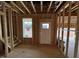 Unfinished basement with window, door, and exposed framing at 9133 Phoenix Ct, Spring Hope, NC 27882