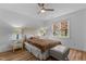 Bright bedroom with a double bed, nightstands, and a window showing fall foliage at 100 Cutty Ct, Cary, NC 27518