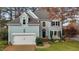 Stunning two-story house, light blue siding, white garage door, autumn foliage at 100 Cutty Ct, Cary, NC 27518