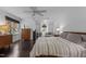 Main bedroom with hardwood floors, large windows, and built-in workspace at 100 Cutty Ct, Cary, NC 27518