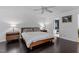 Bright bedroom with a king-size bed, ensuite bathroom, and dark hardwood floors at 100 Cutty Ct, Cary, NC 27518