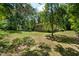 Large backyard with lush greenery and trees surrounding the home at 101 Jeffress Dr, Henderson, NC 27537