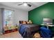 bedroom with green accent wall and built-in shelving at 1024 Deep Canyon Dr, Clayton, NC 27520