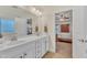 Bathroom with double sinks, view of bedroom, and shower at 105 Valleycruise Cir, Garner, NC 27529