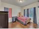 Cozy bedroom with hardwood floors, a plush teddy bear, and ample natural light at 105 Valleycruise Cir, Garner, NC 27529