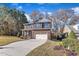 Two-story brick home with gray accents, a two-car garage, and a landscaped lawn at 105 Valleycruise Cir, Garner, NC 27529