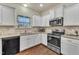 Modern kitchen with white cabinets, granite countertops, and stainless steel appliances at 105 Valleycruise Cir, Garner, NC 27529