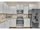 Modern kitchen with granite countertops, stainless steel appliances, and white cabinets at 105 Valleycruise Cir, Garner, NC 27529