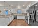 Modern kitchen with white cabinets, granite counters, and stainless steel appliances at 105 Valleycruise Cir, Garner, NC 27529