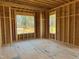 Under-construction home interior, framing of the main living area with large windows at 142 Batten Hill Ln, Selma, NC 27576