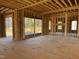 Under-construction home interior, framing the main living area with large windows at 142 Batten Hill Ln, Selma, NC 27576