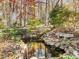 Landscaped backyard with a serene koi pond at 1505 Primrose Ln, Cary, NC 27511