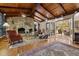 Living room with a large stone fireplace and sunroom access at 1505 Primrose Ln, Cary, NC 27511