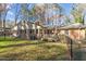 House backyard with deck, fenced yard, and mature trees at 161 Pine Cone Dr, Oxford, NC 27565