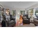 Sunroom with leather armchairs and access to backyard deck at 161 Pine Cone Dr, Oxford, NC 27565