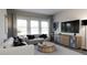 Relaxing living room with comfortable seating and large TV at 1739 Aspen River Lane, Apex, NC 27502