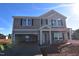 Two-story house with gray siding, attached garage, and stone accents at 20 Calabria Ct, Franklinton, NC 27525