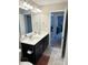 Double vanity bathroom with dark cabinets and a view into another room at 2177 Campbell Loop, Burlington, NC 27215