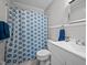 Clean bathroom with white vanity and patterned shower curtain at 2220 May Dr, Burlington, NC 27215