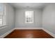 Simple bedroom with hardwood floors and a window at 2220 May Dr, Burlington, NC 27215