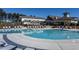 Outdoor pool with lounge chairs and a clubhouse in the background at 2330 Del Webb Gardens Dr, Fuquay Varina, NC 27526