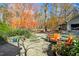 Stone patio with comfortable seating, surrounded by colorful autumn foliage at 2411 Pickard Mountain Rd, Hillsborough, NC 27278