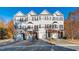 Three-story beige townhouses with attached garages and landscaping at 2606 Wyntercrest Ln, Durham, NC 27713