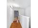 Light-filled hallway with wood floors and access to bedrooms at 2606 Wyntercrest Ln, Durham, NC 27713