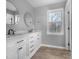 Bathroom with white cabinets, marble countertop and dark fixtures at 3108 Eric St, Willow Springs, NC 27592