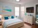 Bedroom with coastal decor, white dresser, and a king-size bed at 3636 Blue Blossom Dr, Raleigh, NC 27616