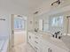 Double vanity bathroom with marble flooring and a view of the bedroom at 4025 Hamlets Chapel Rd, Pittsboro, NC 27312