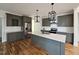 Modern kitchen with stainless steel appliances and gray cabinets at 4025 Hamlets Chapel Rd, Pittsboro, NC 27312