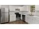 Bright kitchen featuring white cabinets and stainless steel appliances at 602 Dogwood St, Fuquay Varina, NC 27526