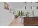 Modern kitchen with dark wood cabinets, white countertops, and stainless steel appliances at 615 W Peace St # 302, Raleigh, NC 27605