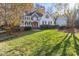 Two story home with brick and white accents, large grassy yard at 6204 Chatford Dr, Raleigh, NC 27612