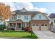 Beautiful two-story home with stone accents and a three-car garage at 628 Peach Orchard Pl Pl, Cary, NC 27519