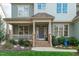 Inviting front porch with a charming blue door and stone steps at 628 Peach Orchard Pl Pl, Cary, NC 27519