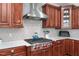 Stainless steel range and hood, white subway tile backsplash, and ample counter space at 628 Peach Orchard Pl Pl, Cary, NC 27519