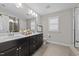 Double vanity bathroom with large mirror and shower at 644 Barneswyck Dr, Fuquay Varina, NC 27526