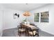 Bright dining room features a wood table, four chairs, and a stylish light fixture at 6506 Garrett Rd, Durham, NC 27707