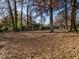 Spacious backyard, partially shaded by trees at 808 Trail One, Burlington, NC 27215