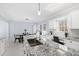 Kitchen island with granite countertop, sink, and breakfast bar seating at 81 Churchwood Ln, Pittsboro, NC 27312